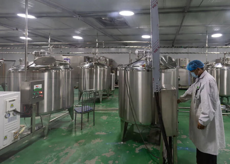 A large stainless steel milk cooling tank