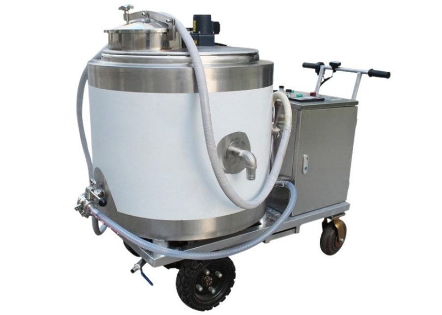 Efficient Calf Feeding System A farm worker using a mobile milk mixer to feed calves in hutches