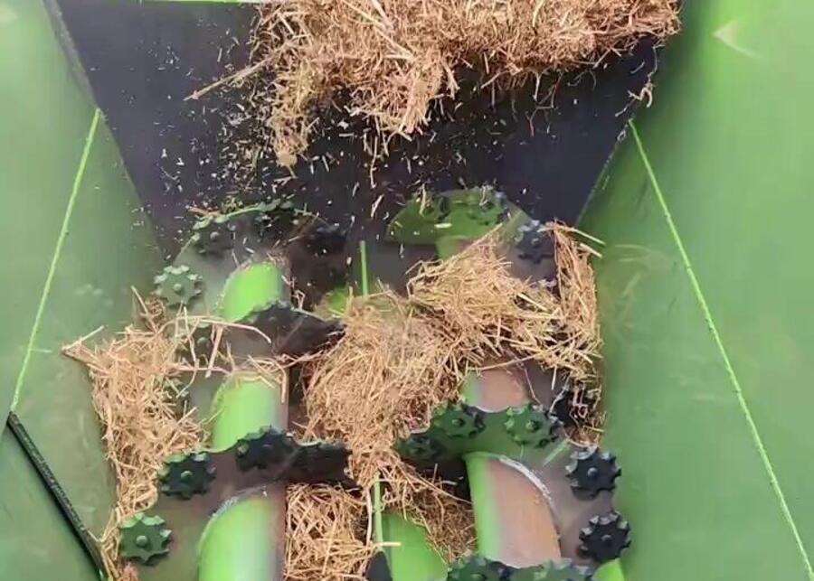 Preparing a TMR Mix Loading hay into a vertical TMR mixer wagon