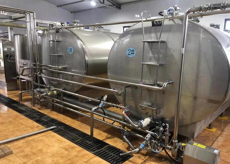 Stainless Steel Milk Cooling Tank A large stainless steel milk cooling tank on a dairy farm