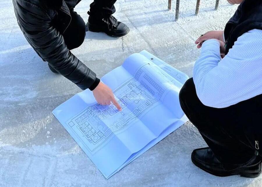 An engineer reviewing plans for a dairy production line