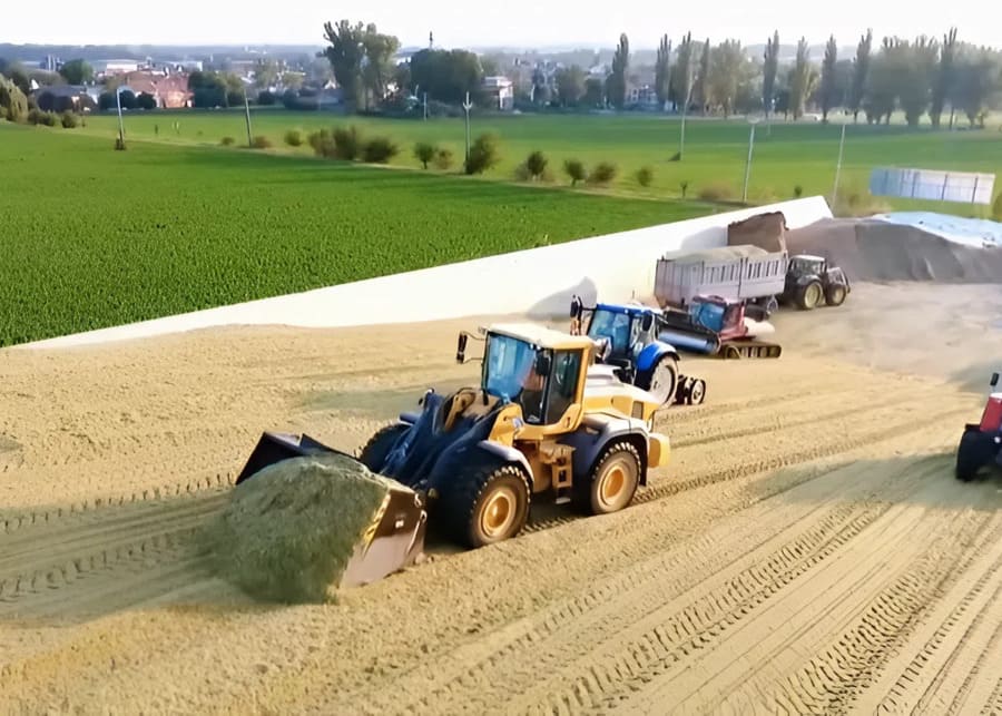 A well-packed silage pit with a loader on top