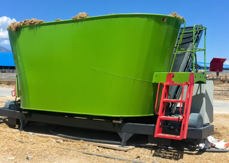 a large TMR mixer in a modern cattle barn