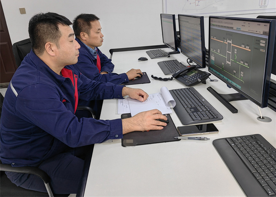 engineers discussing dairy plant blueprints