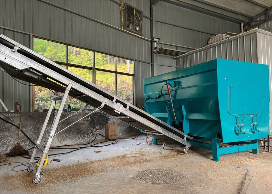 A TMR mixer preparing feed in a modern dairy farm