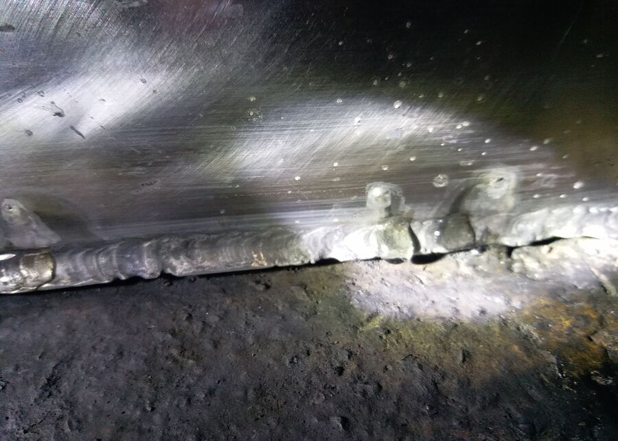 Severe acid corrosion and pitting failure on a poorly welded non-sanitary steel pipe joint due to overheating CIP cycle.