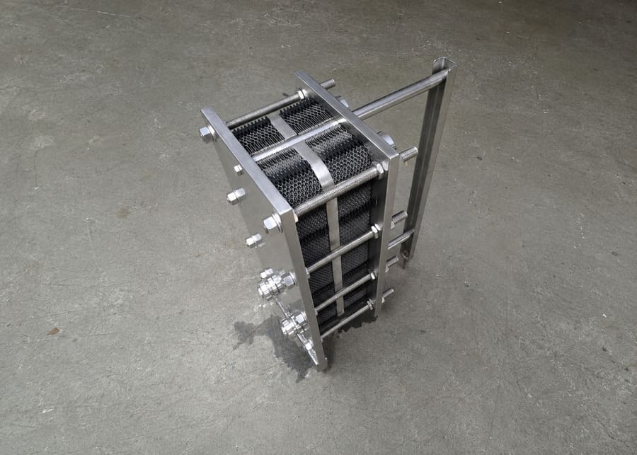 A stainless steel plate heat exchanger in a modern dairy processing facility