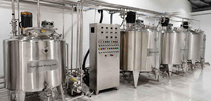High-shear mixing tank and stainless steel blending tanks in farmstead beverage batch processing line