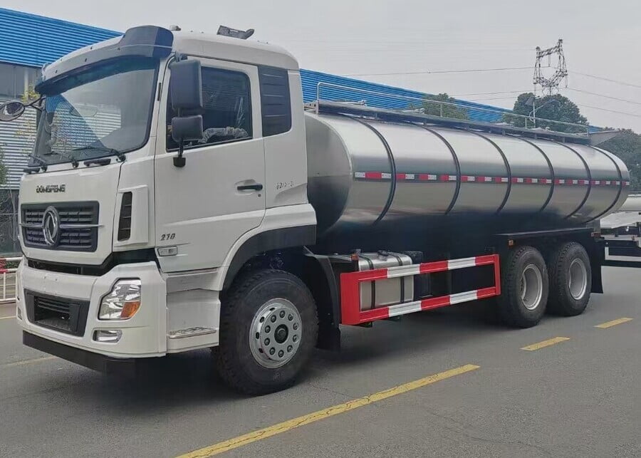 Heavy-duty insulated stainless steel milk transport tank truck for bulk dairy cold chain logistics.