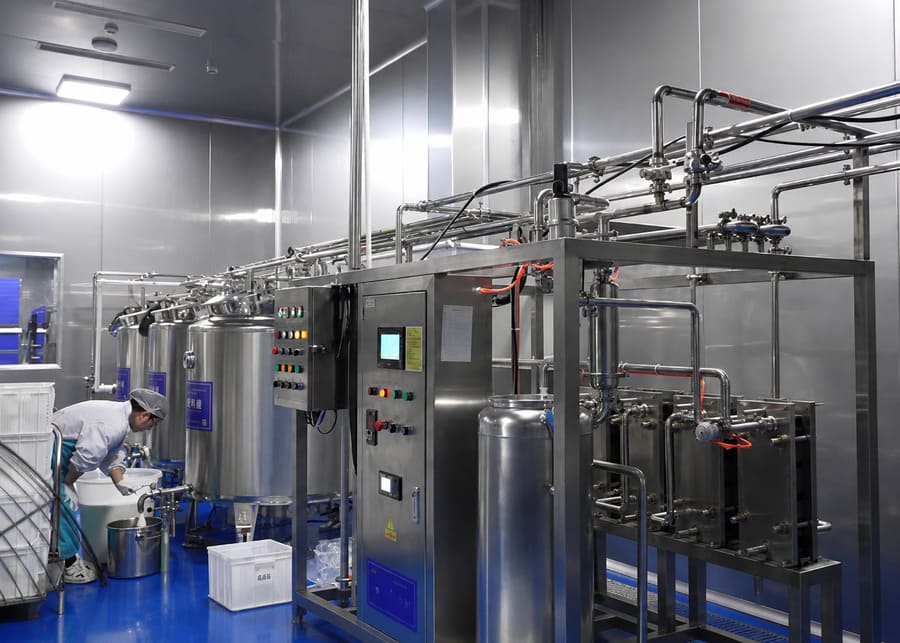 A modern dairy processing facility with stainless steel tanks