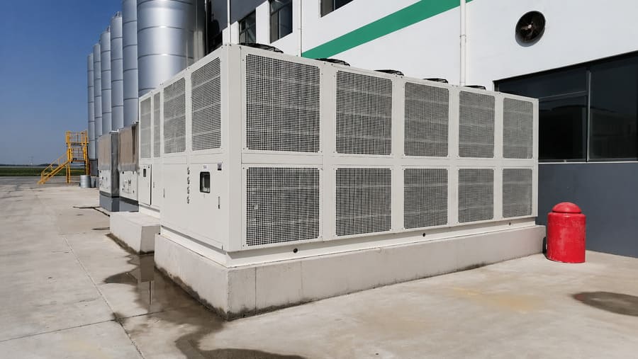 Heavy-duty industrial cooling chiller system installed outside a commercial dairy farm facility.