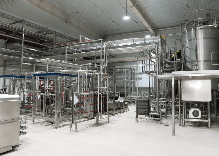 NexAgri automatic yogurt production line featuring multi-section plate heat exchanger units and sanitary stainless steel processing tanks.
