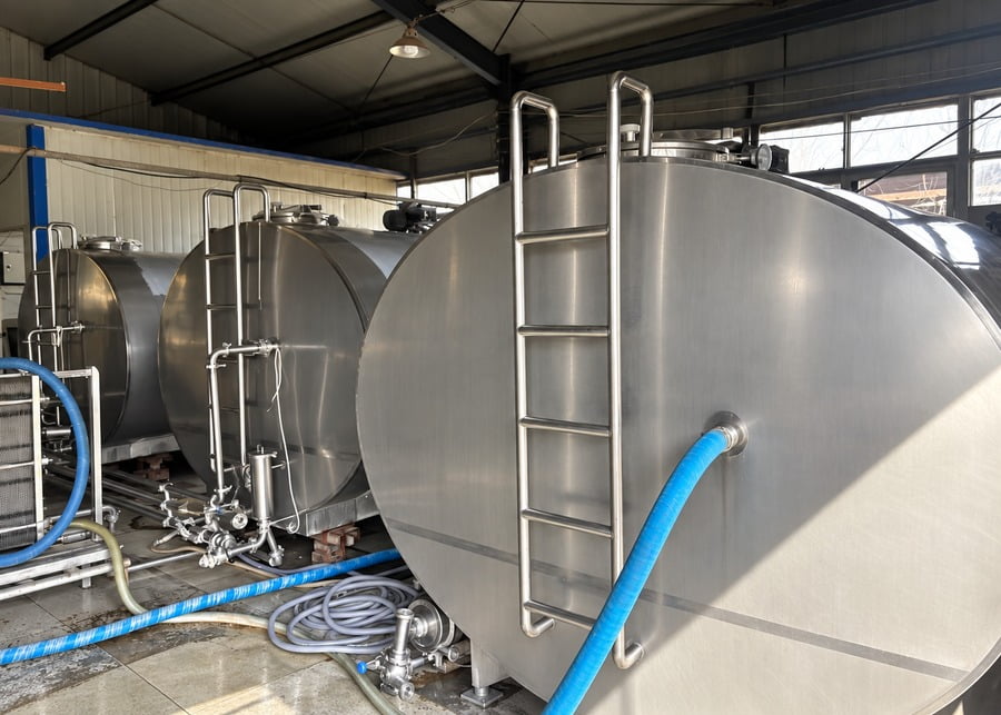 Multiple parallel bulk milk cooling tanks in a commercial dairy milk room for capacity expansion
