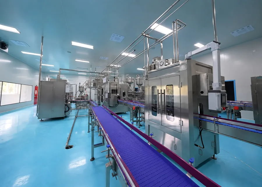 Automated commercial yogurt processing, filling, and packaging line in a sanitary dairy cleanroom